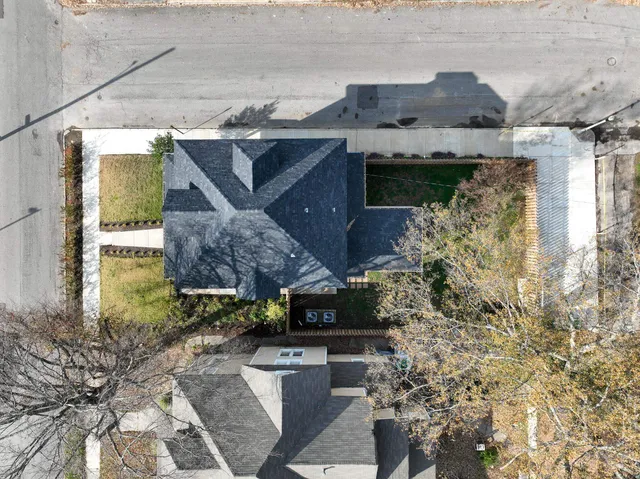 a view of a house with wooden fence