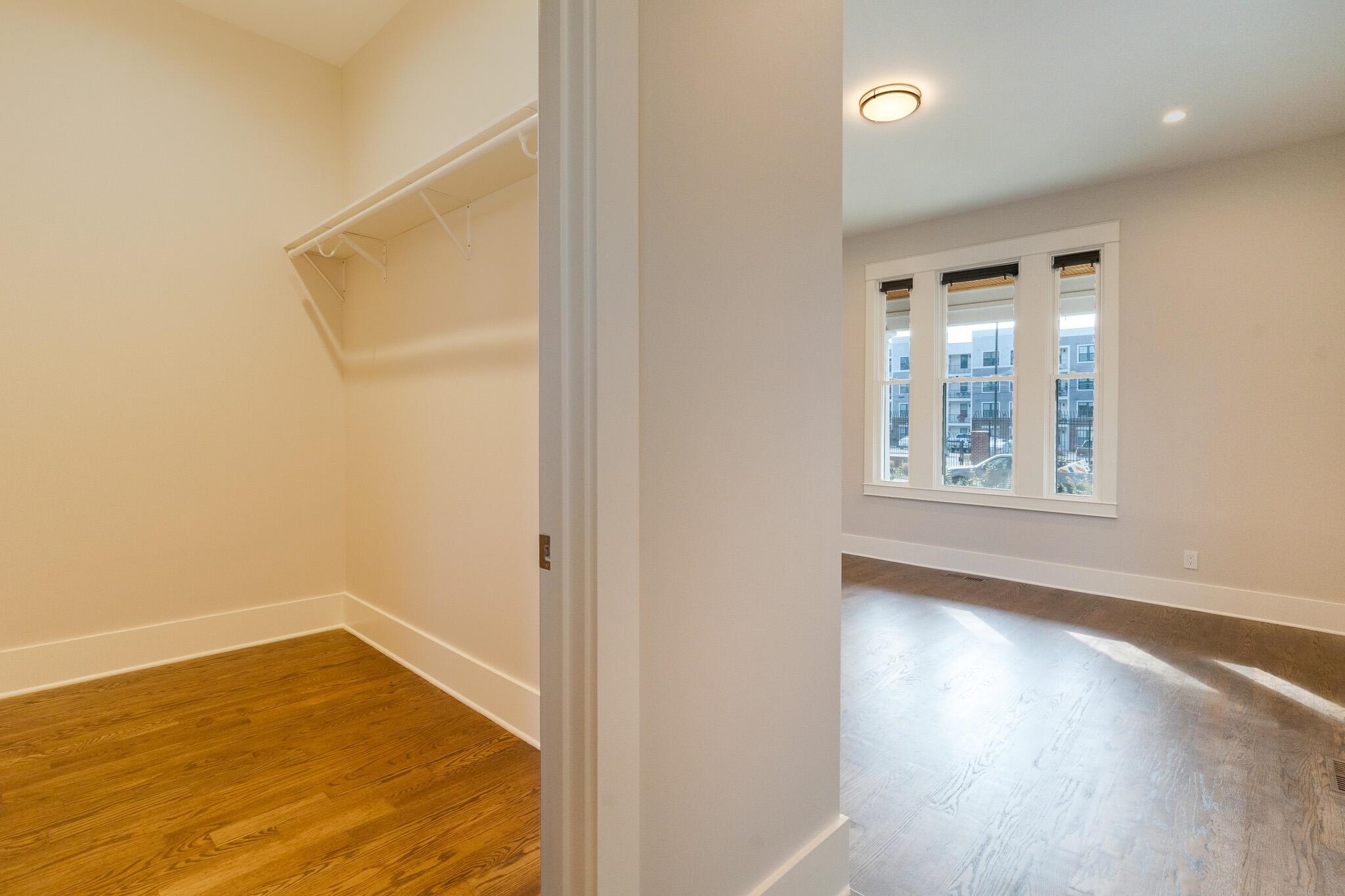 1544 Court Avenue, Unit 1 Memphis, TN 38104 - Photo 28 of 36 an empty room with wooden floor and windows