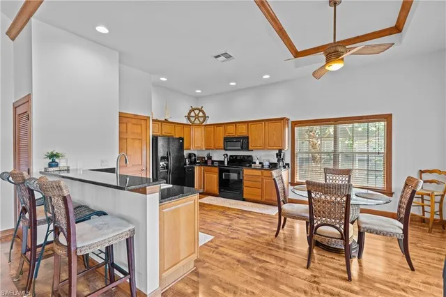 a kitchen with stainless steel appliances granite countertop a refrigerator stove top oven a sink and dishwasher