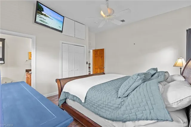 a spacious bedroom with a bed and wooden floor