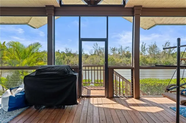 a view of a balcony with floor to ceiling windows with wooden floor