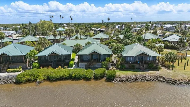 an aerial view of a house with a yard basket ball court and outdoor seating