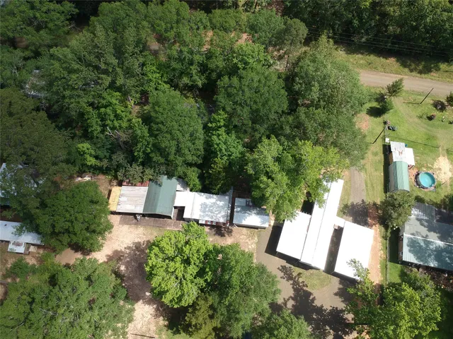 a view of a park with plants and wooden fence