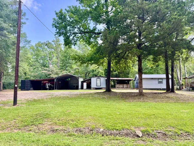 a view of a house with a yard and sitting area