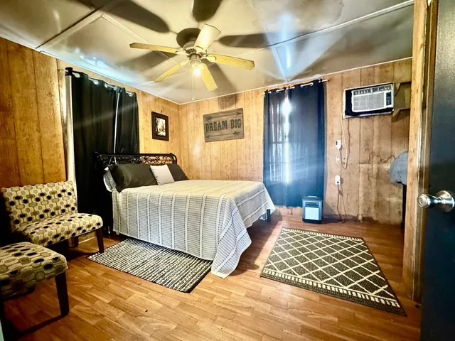 a bedroom with a bed and a chandelier