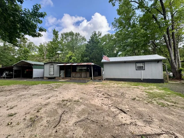 a large kitchen with stainless steel appliances granite countertop a sink and cabinets