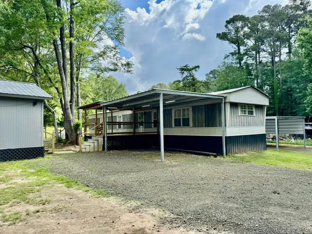 a view of a backyard with swimming pool