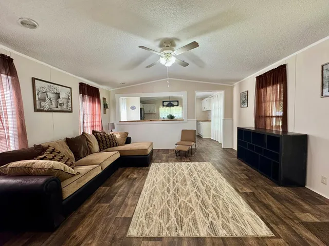 a kitchen with kitchen island a counter space a sink appliances and cabinets