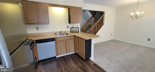 a kitchen with sink cabinets and wooden floor
