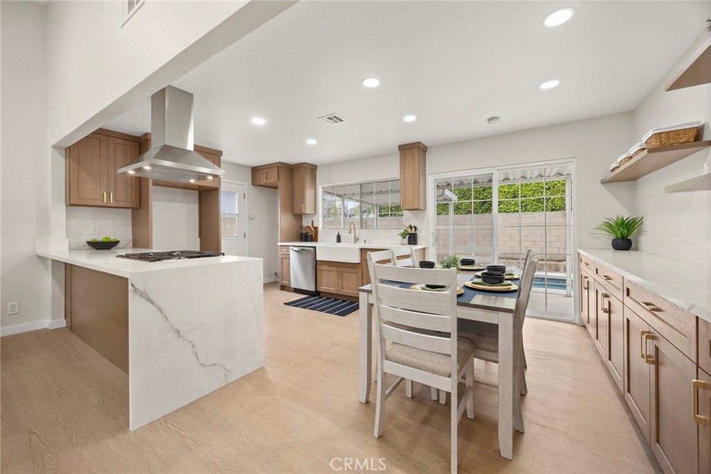 11524 Jerry Street Cerritos, CA 90703 - Photo 7 of 31 The kitchen has a breakfast bar/peninsula with a waterfall edge.