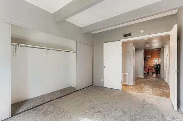 a view of a hallway with wooden shelves