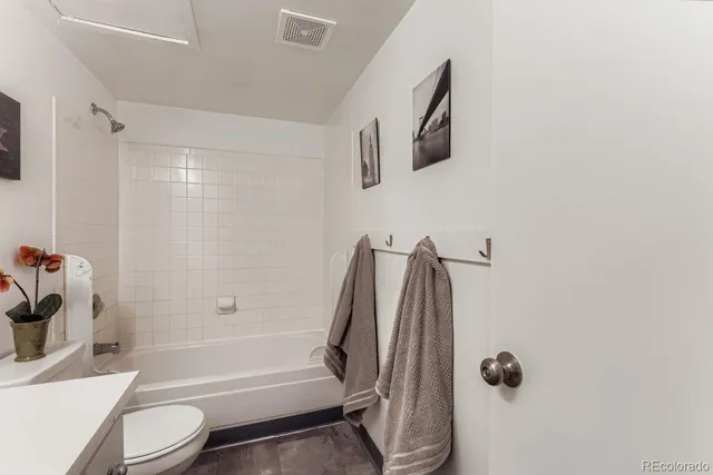 a bathroom with a toilet and a tub