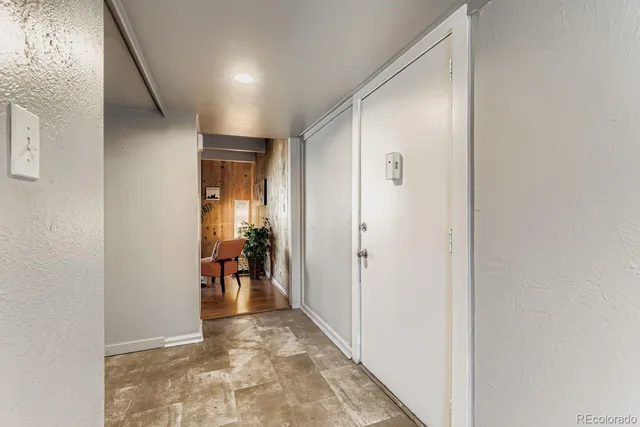 a view of a hallway with dining area and a window
