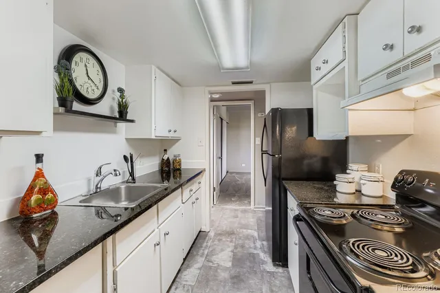 a kitchen with stainless steel appliances granite countertop a stove and a sink