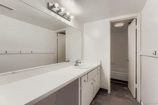 a spacious bathroom with a double vanity sink and a mirror