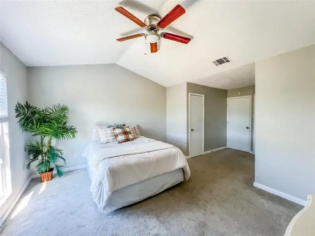 a bedroom with a bed and a potted plant