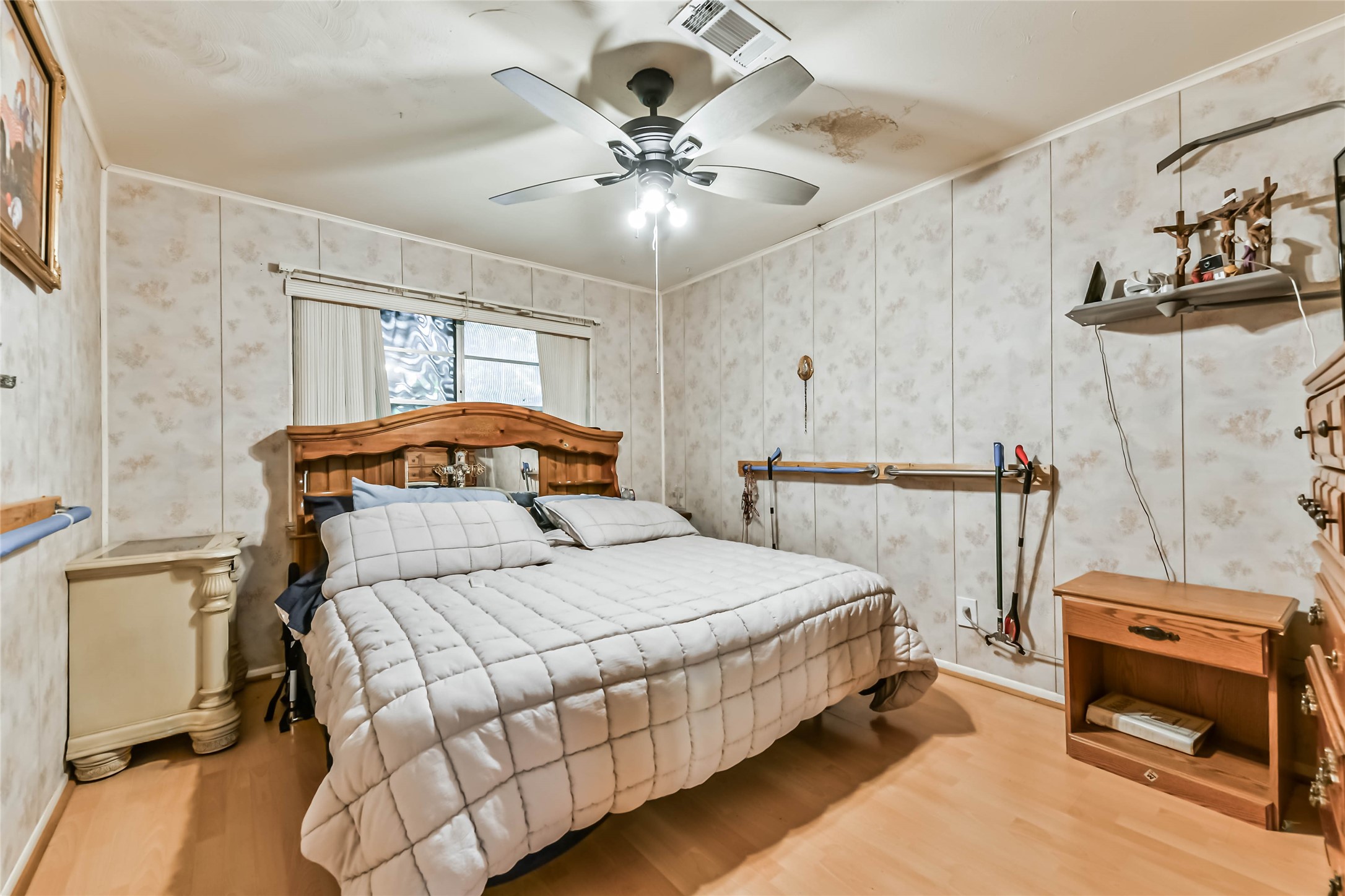 10438 Caxton Street Houston, TX 77016 - Photo 12 of 24 a bedroom with a bed and a chandelier