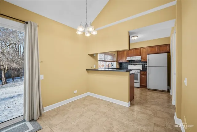 a kitchen with refrigerator and window