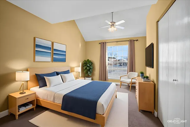 a bedroom with a bed and a large window