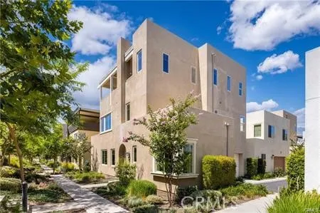 a view of a building with potted plants and large tree