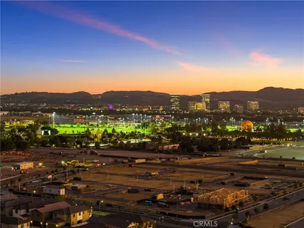 a living room with furniture kitchen view and a large window