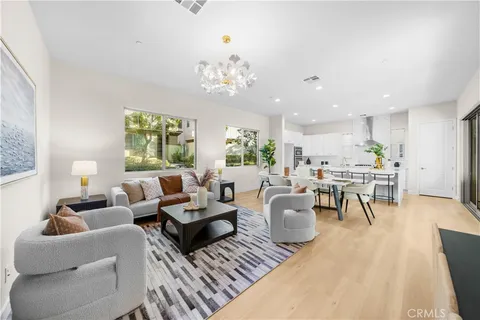 a living room with fireplace furniture and a potted plant