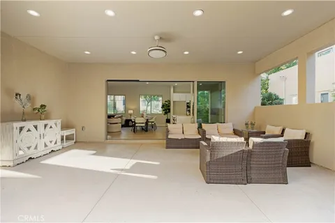 a spacious bedroom with a large bed and a chandelier