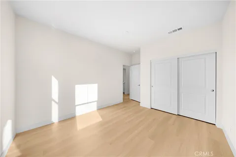 a living room with stainless steel appliances kitchen island granite countertop a sink and cabinets