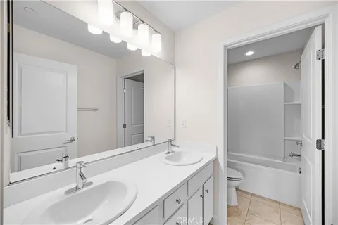 a kitchen with stainless steel appliances granite countertop a sink and cabinets with wooden floor