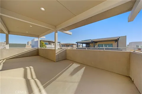 a view of a yard with table and chairs under an umbrella