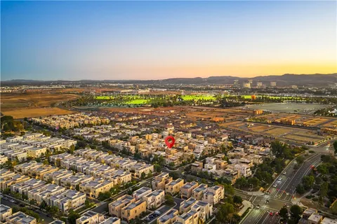 an aerial view of residential houses with city view