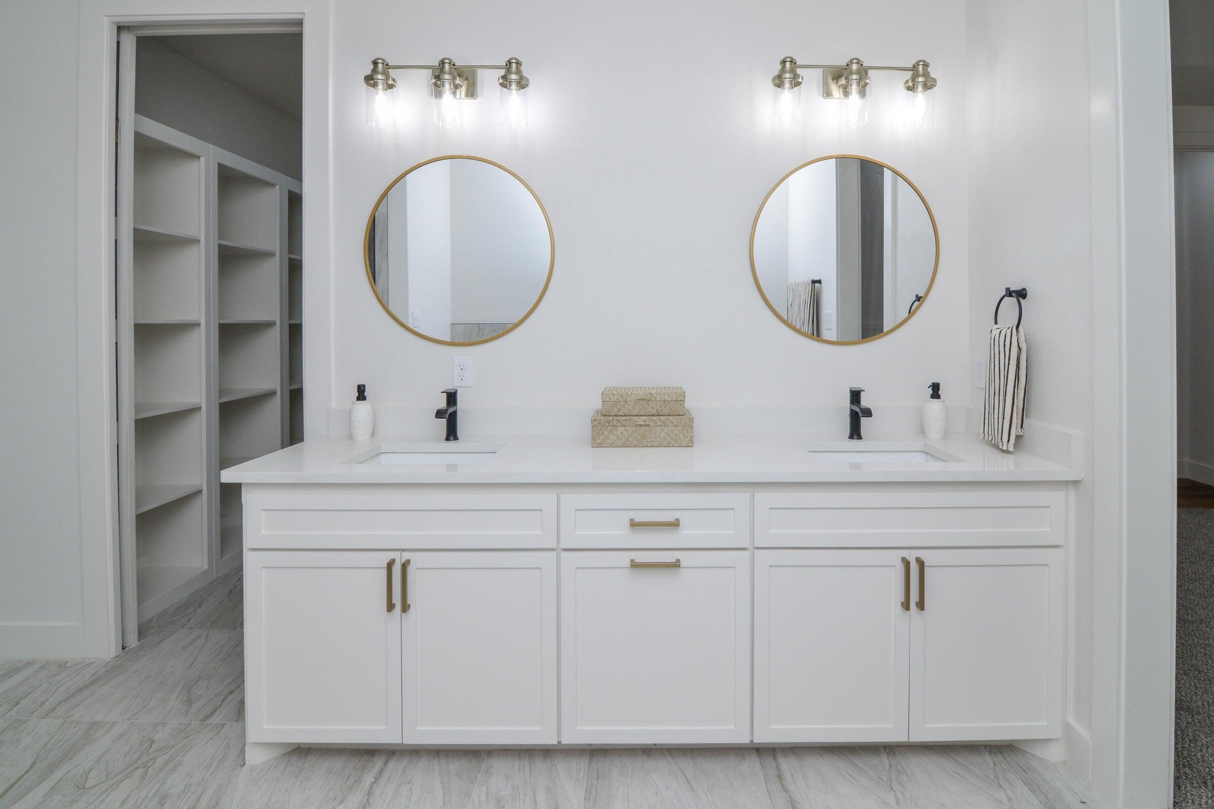 7801 56th Street Lubbock, TX 79407 - Photo 16 of 29 a bathroom with a double vanity sink and a mirror
