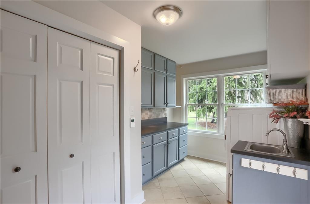 316 Denny Road Valencia, PA 16059 - Photo 19 of 49 This roomy space features heated tile flooring, folding station, custom storage cabinets, a laundry sink and bright windows.