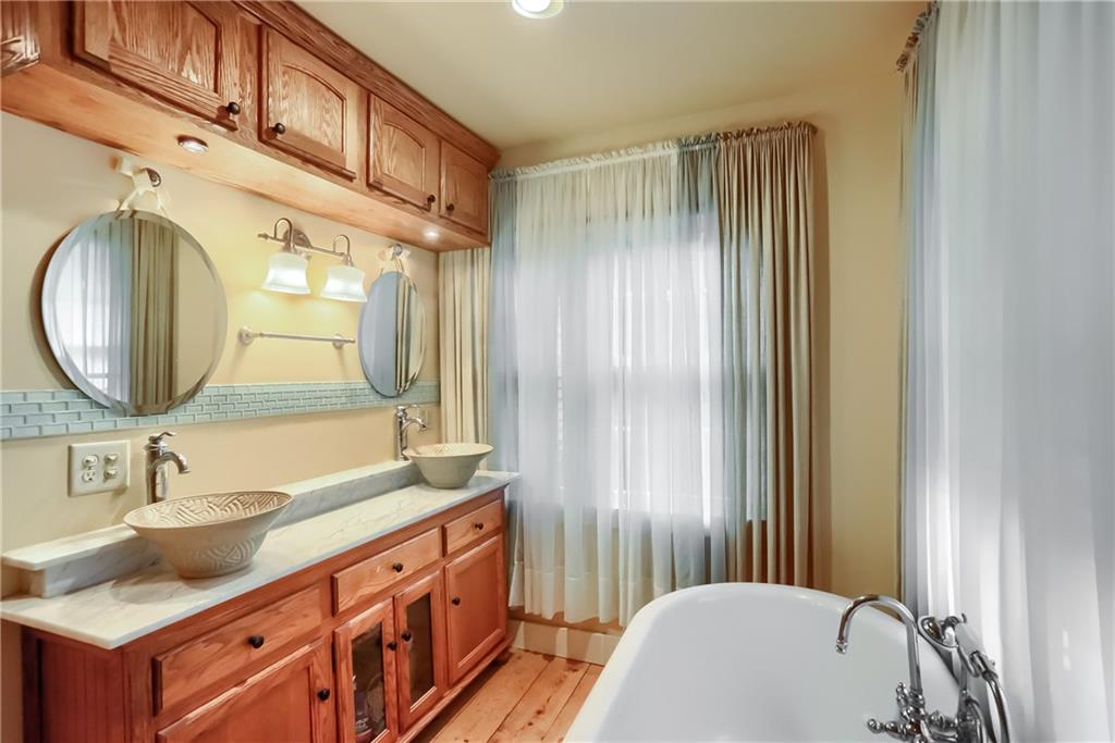 316 Denny Road Valencia, PA 16059 - Photo 23 of 49 A spa like bathroom boasts a stand alone tub, dual vessel sink vanity and tile accents.