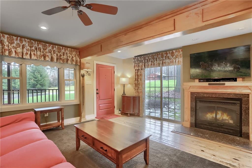 316 Denny Road Valencia, PA 16059 - Photo 5 of 49 Relax near the cozy fireplace, flanked with sliding doors to the exterior, on a chilly evening.