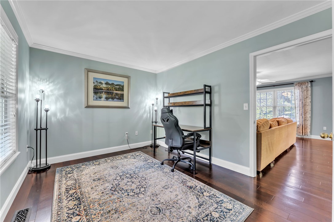 154 Hammond School Road Anderson, SC 29621 - Photo 5 of 33 An inviting room boasts rich wood floors and crown molding.