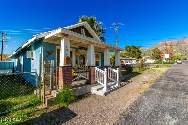 a view of a house with a small yard and floor to ceiling window