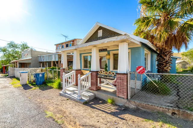 a view of a house with a yard patio and furniture