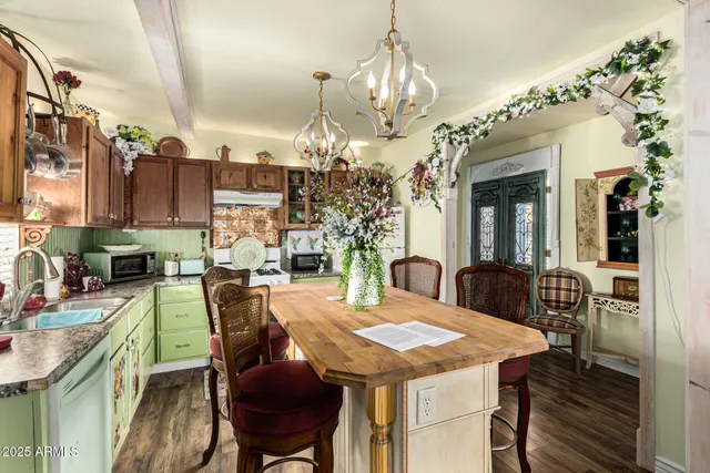 a view of a dining room with furniture and chandelier