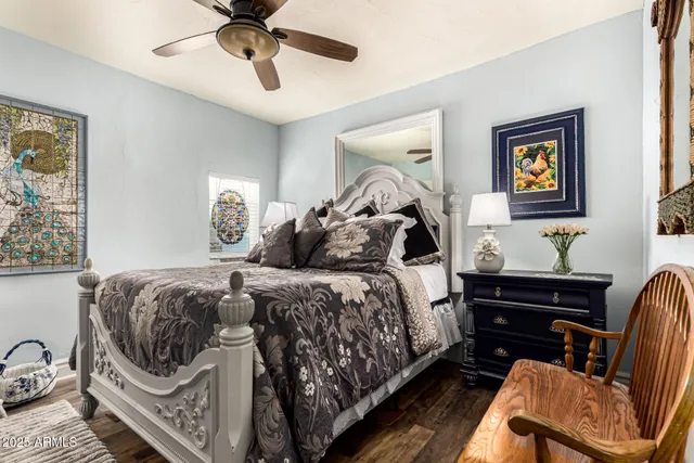 a bedroom with a bed and a chandelier