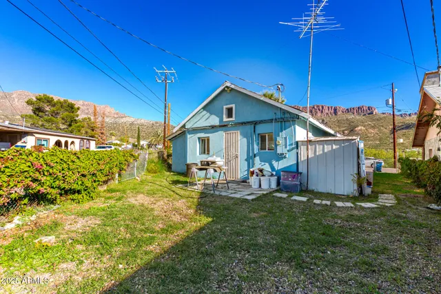 a view of a house with backyard porch and sitting area