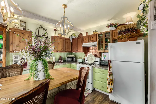 a dining room with furniture a kitchen and chandelier