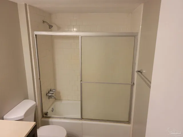 a bathroom with a shower and a toilet
