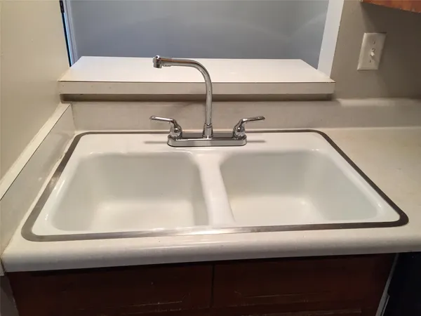 a view of a hallway with wooden floor and chandelier