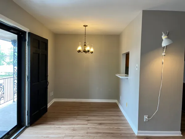 a view of a room with wooden floor