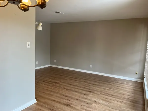 a view of walk in closet with wooden floor