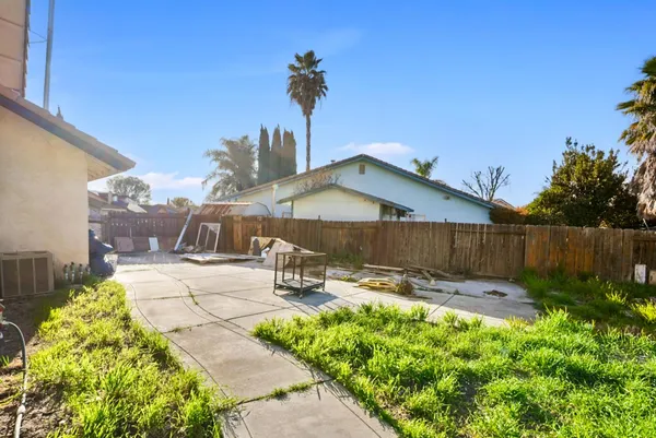 a backyard of a house with table and chairs