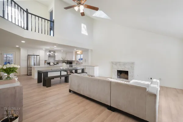 a living room with furniture and kitchen view