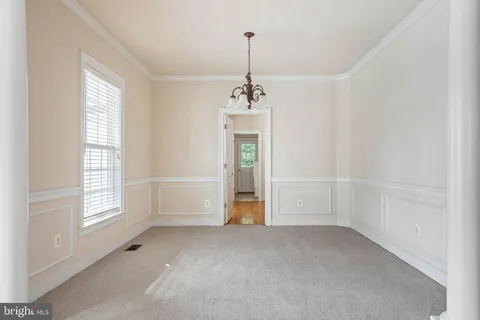 a view of a kitchen with wooden floor and a ceiling fan