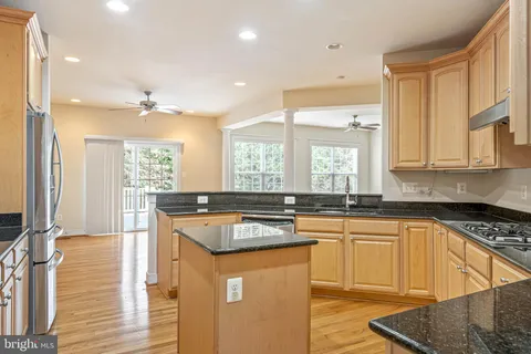 a bedroom with a bed potted plant on dresser and a window